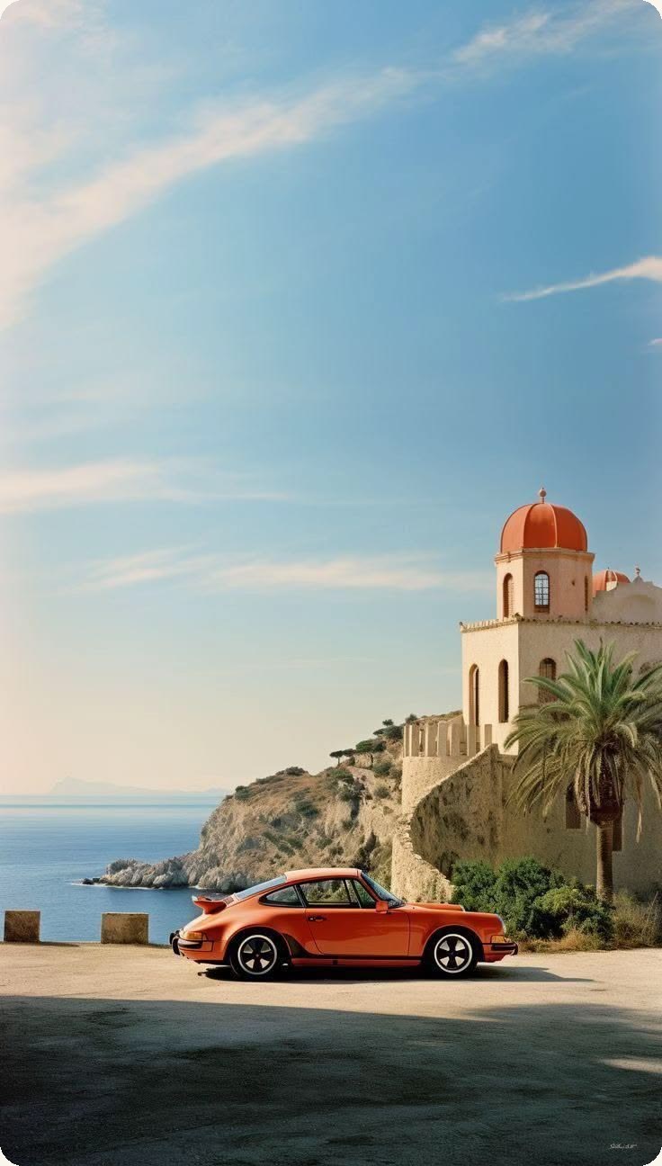 @Image 2 — the environment and the car: terrace, tower, palm, sea, and the orange coupe.